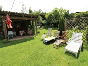 a group of chairs sitting on the grass in a yard at Holiday home in Wernberg with pool and sauna in Wernberg