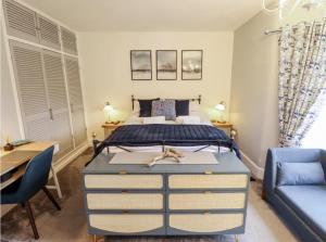 a bedroom with a bed and a desk and a couch at Luxury Lincoln Home with hot tub sleeps 8 in Lincoln