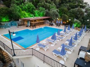 an overhead view of a pool with blue and white chairs at LESLION HOTEL TURUNC in Marmaris