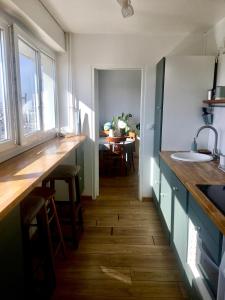 a kitchen with a counter and a sink and a table at Perfect for couples+children / baby friendly /50m² in Paris