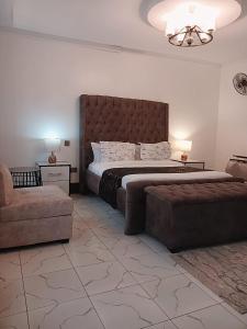 1 dormitorio con 1 cama grande y 1 sofá en Cacecy Luxury Homes 2 -Bedroom en Bungoma
