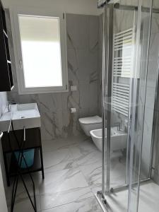 a bathroom with a shower and a toilet and a sink at Residence La Margherita in Lazise