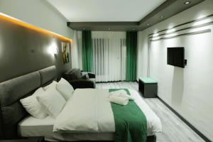 Habitación de hotel con cama y sofá en Aybek Ratio Hotel en Çanakkale