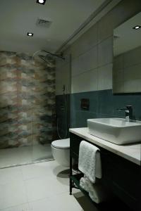 ein Bad mit einem Waschbecken und einem WC in der Unterkunft Aybek Ratio Hotel in Canakkale