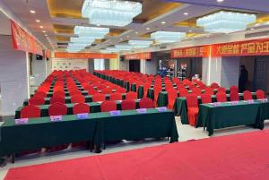 a large room with red chairs and tables in it at Ramada Linyi North in Linyi