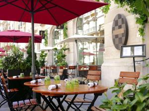 a patio with two tables and an umbrella at Sofitel Paris Arc De Triomphe in Paris