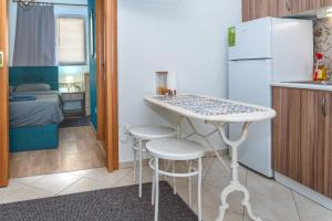 a small kitchen with a table and two stools at Modern Apt Upon Tsimiski in Thessaloniki