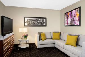 a living room with a couch and a flat screen tv at Hyatt Regency Savannah in Savannah