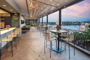 a restaurant with tables and chairs on a balcony at Hyatt Regency Savannah in Savannah