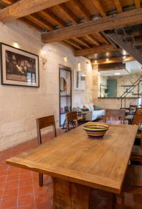 a wooden table with a bowl on top of it at Maison de charme en centre-ville 4 à 6 personnes in Arles +7 photos