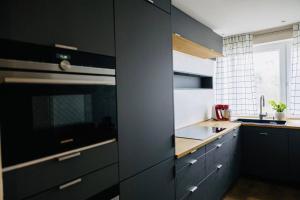 a kitchen with black cabinets and a stove top oven at Wohlfühloase in perfekter Lage in Stuttgart