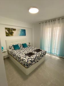 Una cama o camas en una habitación de Apartamento VI-DA PLAYA