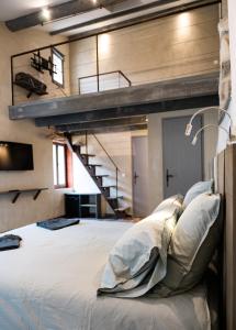 a bedroom with a large bed with a loft at Maison de charme en centre-ville 4 à 6 personnes in Arles