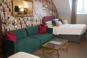 a living room with a couch and a mirror at Tower Hotel in Lincoln