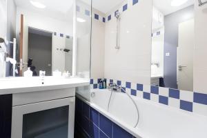 a bathroom with a shower and a sink at Aparthotel Chez Adagio Paris La Défense-2P with Terrace in Courbevoie