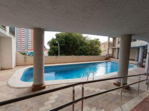a large swimming pool in a building with a building at Pueblo Español in Cullera