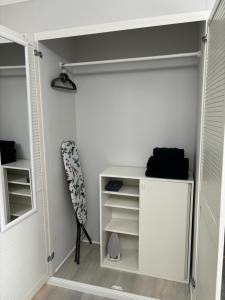 a closet with a white door and a shelf at Apartment Hartenrod in Bad Endbach