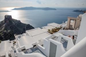 a view of the ocean from the top of a white building at Heavens Edge in Imerovigli