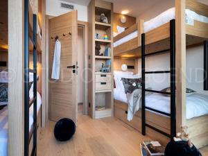 a room with two bunk beds and a closet at Résidence Eden - Chalets pour 14 Personnes 124 in Arc 1800