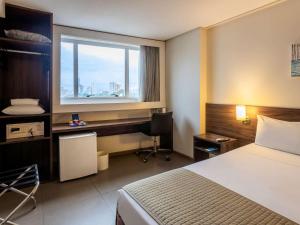 Ένα ή περισσότερα κρεβάτια σε δωμάτιο στο Ibis Styles Belém Hangar