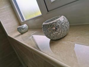 two vases sitting on a counter next to a window at Stunning 3 Bedroom 5 beds House in Wolverhampton in Wolverhampton