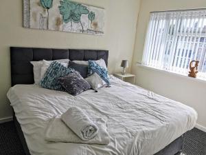 a bedroom with a large bed with pillows on it at Stunning 3 Bedroom 5 beds House in Wolverhampton in Wolverhampton