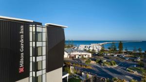 an aerial view of a building and the ocean at Hilton Garden Inn Busselton in Busselton