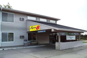 a store with a sign on the side of a building at Super 8 by Wyndham Grand Island in Grand Island