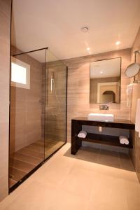 a bathroom with a glass shower and a sink at CALIMERA Delfino Beach Resort & Spa in Nabeul