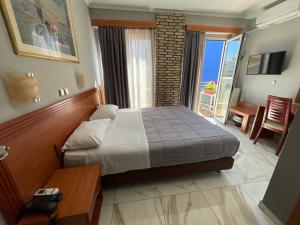 a bedroom with a bed and a table and a room with at Piraeus Acropole Hotel in Piraeus