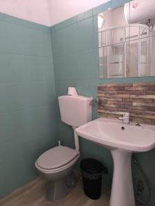 a bathroom with a toilet and a sink at Laughing Seagull in Albufeira