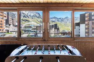 a room with a pool with a view of a city at Résidence Valset - 3 Pièces pour 9 Personnes 984 in Val Thorens