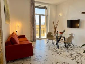 a living room with a couch and a table at Hotel Exclusive in Agrigento