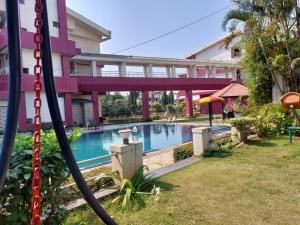 a swimming pool in front of a building at Imperial Grande Resort in Lonavala