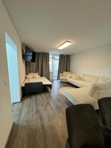 a living room with a couch and a tv in it at Apartment in Bonn +5 photos