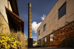 a tall brick smoke stack next to a building at Wellness hotel Lihovar in Třemošnice