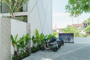 a row of scooters parked outside of a building at Deluxe apartments Canggu area with gym coworking security parking and full services in Tumbak Bayuh