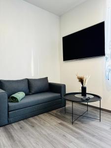 a living room with a couch and a table at Modern Studio Apartment in Riga in Rīga