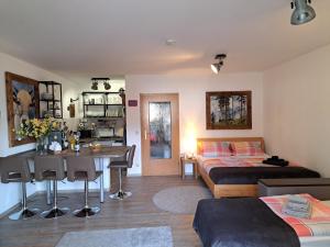 a bedroom with a bed and a desk and a bed and a table at Ferienappartement Austen in Piding