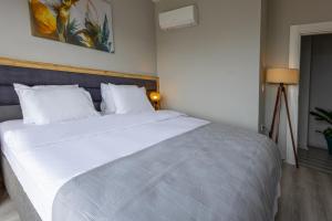 a bedroom with a large white bed with white pillows at ZAL SUİTE in Trabzon