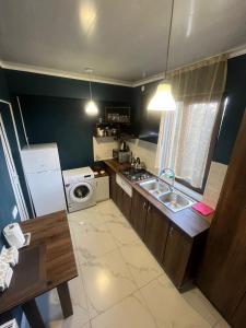 a kitchen with a sink and a washing machine at garden and panorama in Mtskheta