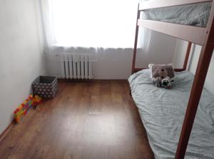 a bedroom with a bunk bed with a teddy bear on it at Apartament Sol in Radom