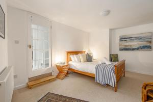 a bedroom with a bed and a window at Harbour Hideaway St Monans in Saint Monance