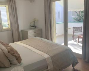 a bedroom with a bed and a door to a patio at Villa Dyrrahu with Pool & Sea Access in Golem +72 photos