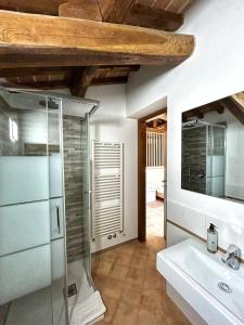 a bathroom with a glass shower and a sink at CasalPiano in Orvieto