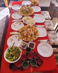 a long table with plates of food on it at Apartmani Božana Vojinović in Žabljak