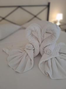 a pile of towels sitting on top of a bed at Exclusive Loft degli Artisti in Florence