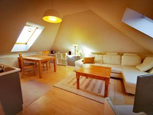 a living room with a couch and a table at Rügenblick in Lubmin