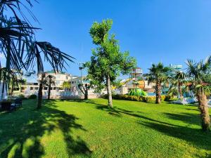 a green park with palm trees and buildings at Sapanca Aqua Wellness Spa Hotel in Sapanca