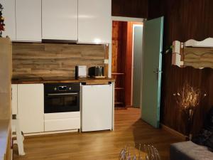 a kitchen with white cabinets and a stove top oven at Appartement Villard-de-Lans, 2 pièces, 6 personnes - FR-1-689-129 in Villard-de-Lans